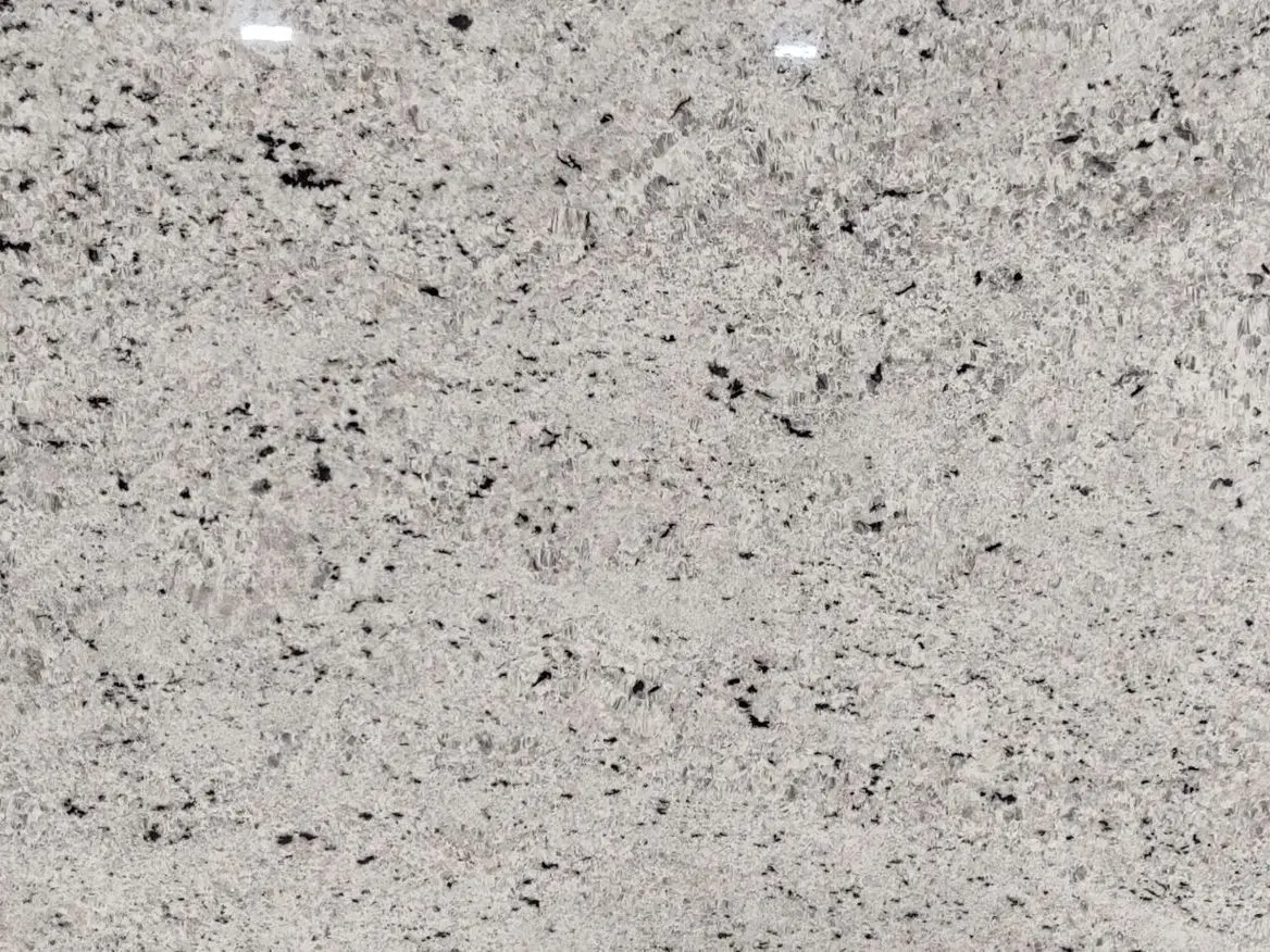 Colonial White Granite Slab Specifications Primary Color(s): White Accent Color(s): Gray, Black, Cream Material Type: Granite Price Range: Medium Finish: Polished (Other finishes available upon request) Slab Thickness: Available in multiple thicknesses upon request Country of Origin: India Colonial White Granite